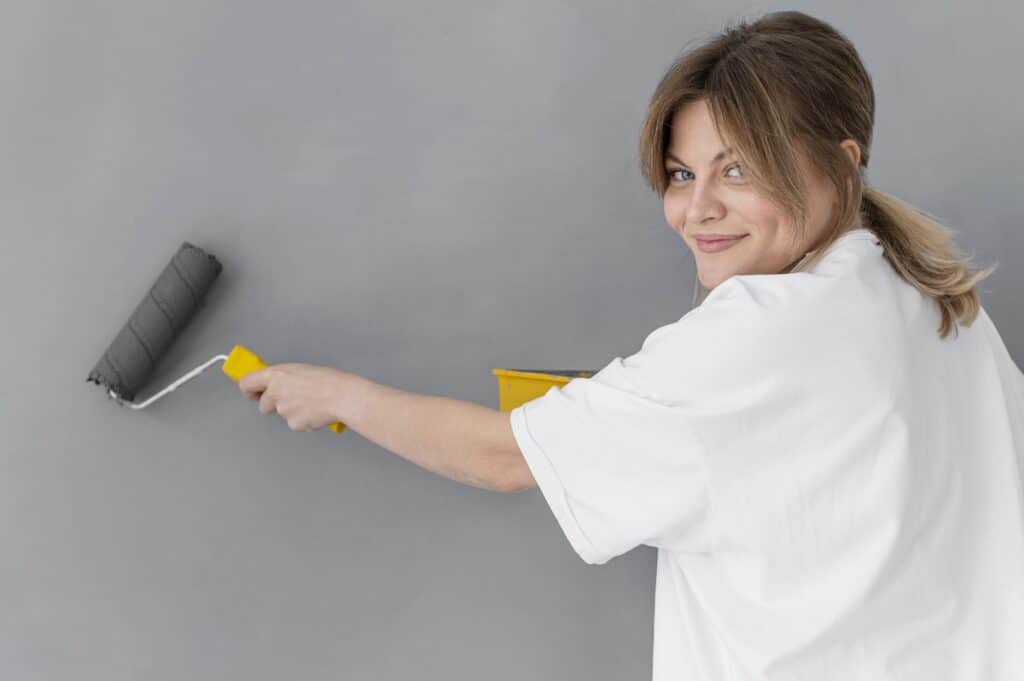 Woman using a roller paint